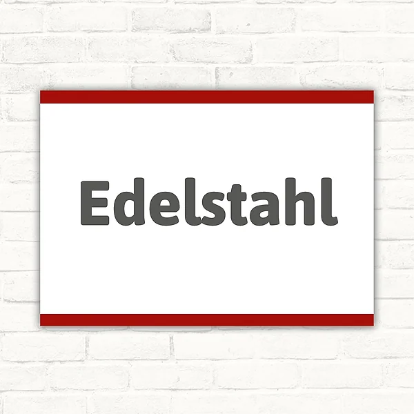 Schild mit dem Wort Edelstahl in dunkelgrauer Schrift auf weißem Hintergrund im Querformat.