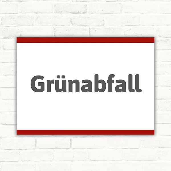 Schild mit dem Motivtext „Grünabfall“ in dunkelgrauer Schrift auf weißem Hintergrund mit rotem Rand.