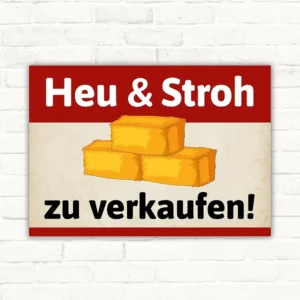 Schild mit der Aufschrift Heu & Stroh zu verkaufen und Strohballen-Motiv