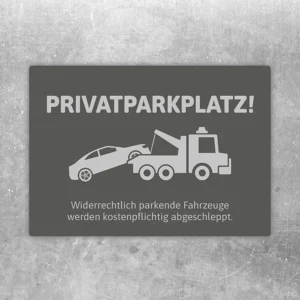 Grauer Aufkleber mit Privatparkplatz-Hinweis und Abschlepper für reservierte Stellflächen.