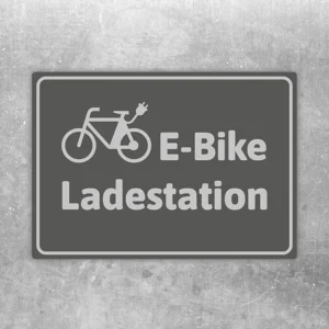 Grauer Aufkleber mit Fahrradsymbol und der Beschriftung E-Bike Ladestation.