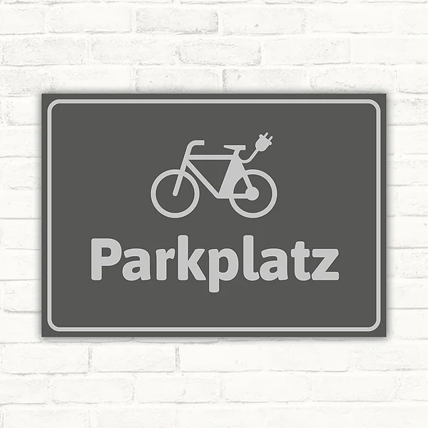 Grauer Schild mit E-Bike-Symbol und dem Wort Parkplatz für klare Stellplatzkennzeichnung.