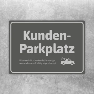 Grauer Aufkleber mit der Aufschrift Kunden-Parkplatz und Abschlepper-Symbol für reservierte Stellflächen.