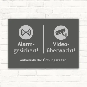 Schild mit Alarm- und Videoüberwachungs-Hinweis außerhalb der Öffnungszeiten