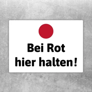 Aufkleber mit rotem Punkt und dem Text Bei Rot hier halten für klare Hinweisbereiche