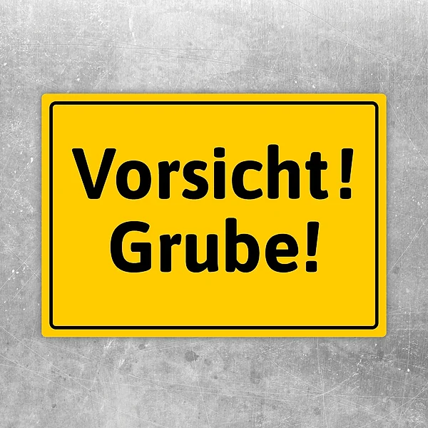 Gelber Aufkleber mit dem Warntext Vorsicht! Grube! für Gefahrenstellen und Baustellenbereiche.