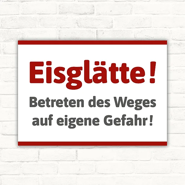 Schild mit der Aufschrift „Eisglätte – Betreten auf eigene Gefahr“ als klare Kennzeichnung