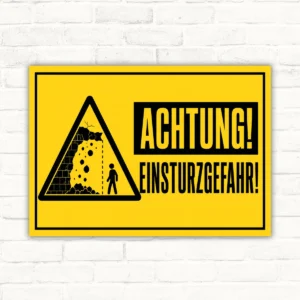 Warnschild mit gelbem Hintergrund, Warndreieck und dem Text „ACHTUNG! EINSTURZGEFAHR!“, als bedruckte Platte.