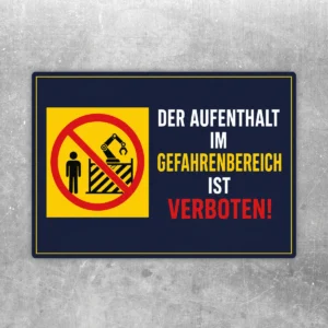 Querformatiger Aufkleber mit der Aufschrift „Der Aufenthalt im Gefahrenbereich ist verboten“ in Gelb, Rot, Weiß und Dunkelblau.