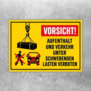 Warnaufkleber mit Kranhaken, schwebender Last und dem Text Vorsicht Aufenthalt und Verkehr unter schwebenden Lasten verboten.