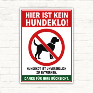 Hundeklo Schild mit rotem Hinweis „Hier ist kein Hundeklo!“ und durchgestrichenem Hund, als bedrucktes Schild.