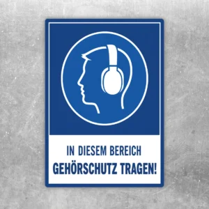 Gehörschutz tragen Aufkleber mit blau-weißem Warnmotiv und Text „In diesem Bereich Gehörschutz tragen!“