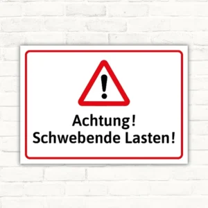 Warnschild mit dem Text „Achtung! Schwebende Lasten!“ in Rot, Schwarz und Weiß