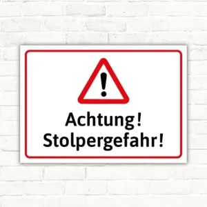 Warnschild mit rotem Warnsymbol und dem Text Achtung Stolpergefahr