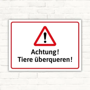Warnschild mit rotem Warndreieck und dem Text „Achtung! Tiere überqueren!“