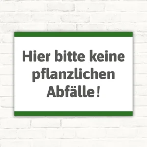 Querformatiges Schild mit dem Text „Hier bitte keine pflanzlichen Abfälle!“ in Dunkelgrau auf weißem Hintergrund mit grünem Rand.