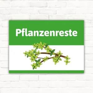 Schild mit der Aufschrift Pflanzenreste und einem Zweig mit grünen Blättern