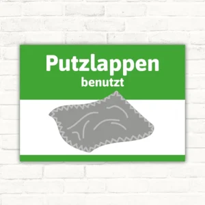 Putzlappen benutzt Schild mit grünem Kopfbereich und grauem Putzlappen-Symbol