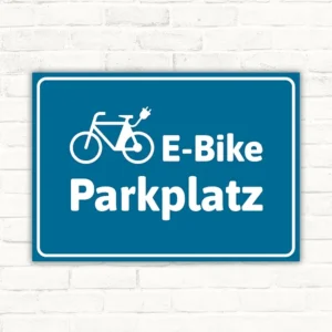 Schild E-Bike-Parkplatz blau mit Fahrradpiktogramm für klar gekennzeichnete Stellflächen.
