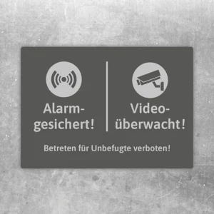 Aufkleber mit Alarm- und Videoüberwachungssymbolen sowie dem Hinweis auf unbefugtes Betreten.