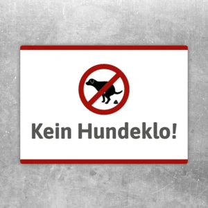Aufkleber mit rotem Verbotssymbol und dem Hinweis „Kein Hundeklo“ für klare Bereiche.
