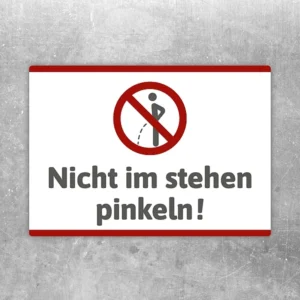 Aufkleber mit Verbotssymbol und Text „Nicht im Stehen pinkeln!“ für das WC