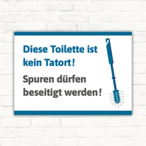 Schild mit der Aufschrift Diese Toilette ist kein Tatort und Bürstenmotiv für den WC-Hinweis.