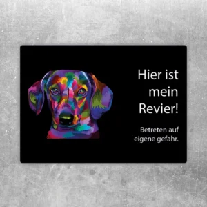 Aufkleber mit buntem Dackel und dem Hinweis: Hier ist mein Revier, betreten auf eigene Gefahr.