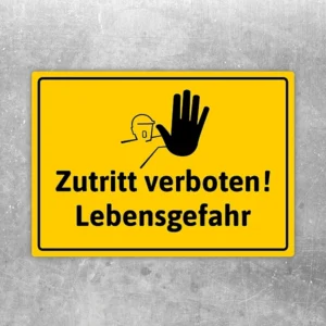 Gelber Aufkleber mit der Aufschrift „Zutritt verboten! Lebensgefahr“ für Gefahrenbereiche.