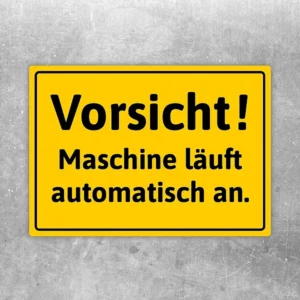 Gelber Aufkleber mit dem Hinweis „Vorsicht! Maschine läuft automatisch an.“ für Maschinenbereiche.