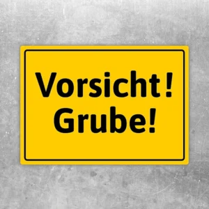 Gelber Aufkleber mit dem Warntext Vorsicht! Grube! für Gefahrenstellen und Baustellenbereiche.