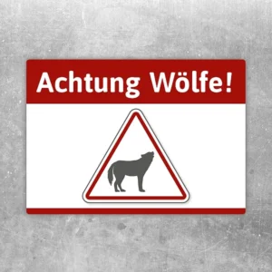 Aufkleber mit dem Hinweis Achtung Wölfe und Wolfssymbol als Warnmotiv.