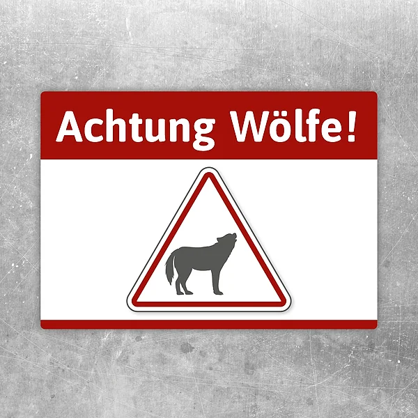 Aufkleber mit dem Hinweis Achtung Wölfe und Wolfssymbol als Warnmotiv.