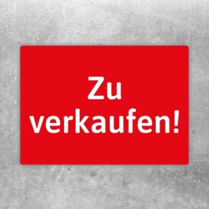 Roter Aufkleber mit dem Schriftzug „Zu verkaufen“ als auffälliger Verkaufs-Hinweis.