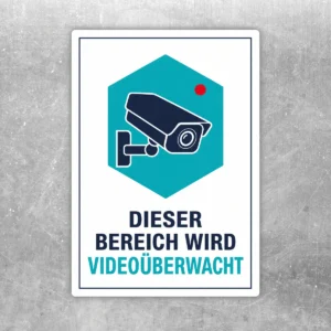 Videoüberwachtes Aufkleber-Schild mit Kamera-Motiv, türkisem Feld und der Aufschrift „Dieser Bereich wird videoüberwacht“.