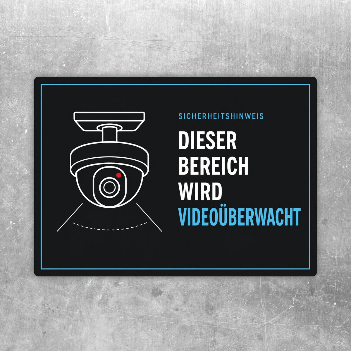 Videoüberwachungs-Aufkleber mit Kamerasymbol und Text „Dieser Bereich wird videoüberwacht“ in Schwarz, Weiß, Blau und Rot.