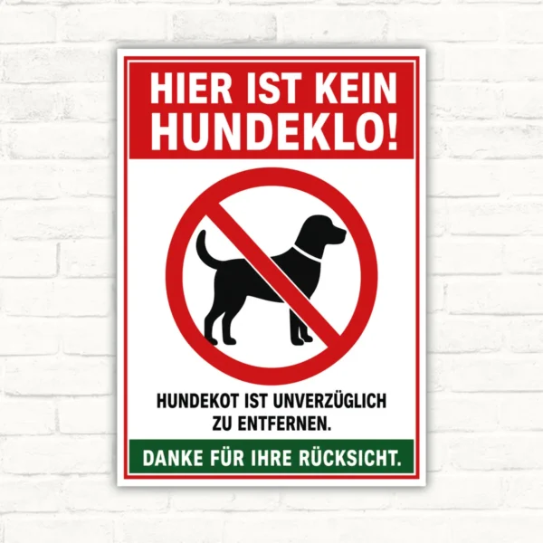 Hundeklo Schild mit rotem Hinweis „Hier ist kein Hundeklo!“ und durchgestrichenem Hund, als bedrucktes Schild.