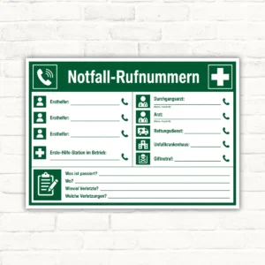 Notfall-Rufnummern Aushang als grün-weißes Hinweisschild mit Ersthelfer-, Arzt- und Rettungsdienst-Feldern für den Betrieb.