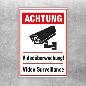Videoüberwachung Aufkleber mit rotem Warnkopf, Kamerasymbol und zweisprachigem Hinweis in Schwarz-Weiß.