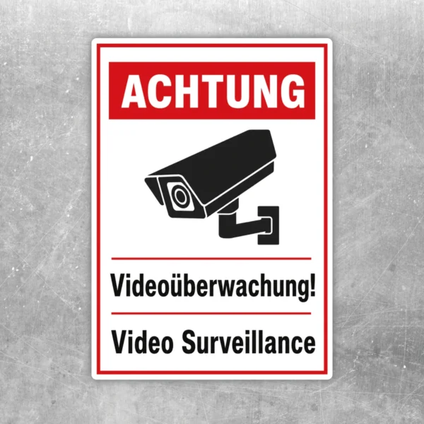 Videoüberwachung Aufkleber mit rotem Warnkopf, Kamerasymbol und zweisprachigem Hinweis in Schwarz-Weiß.