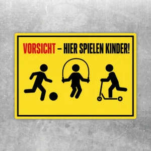 Vorsicht hier spielen Kinder Aufkleber im Querformat mit gelbem Warnhintergrund, schwarzem Rand und roten Akzenten.