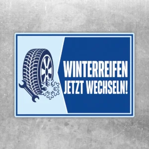 Blau-weißer Winterreifen jetzt wechseln Aufkleber mit Reifenmotiv, Werkzeug und Schneeflocke im Querformat.
