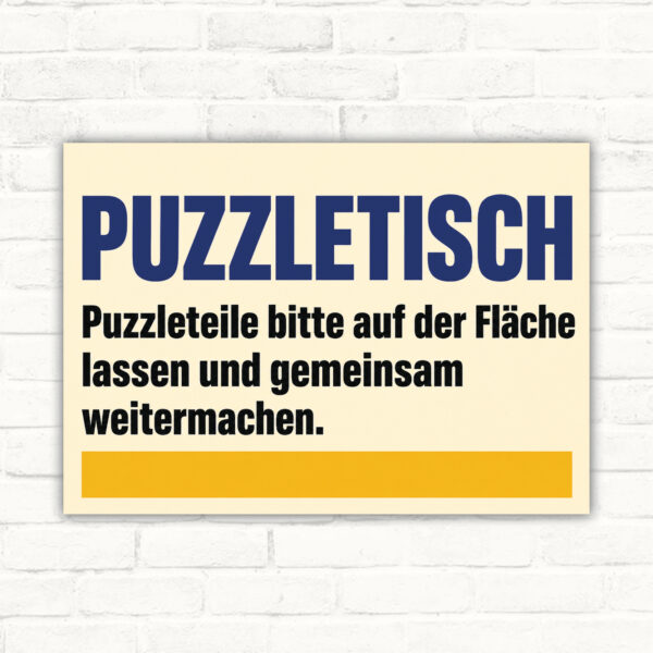 Hinweisschild Puzzletisch – Puzzleteile auf der Fläche lassen mit gut lesbarem Motiv und klarer Beschriftung als bedrucktes Schild aus Aluminium-Verbundplatte.