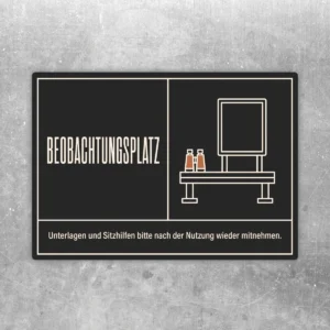 Beobachtungsplatz Aufkleber in Schwarz und Beige mit Bankmotiv und Hinweis zum Mitnehmen von Sitzhilfen.
