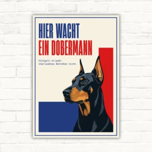 Dobermann Schild mit Wortlaut „Hier wacht ein Dobermann“, Hundekopf-Motiv und Hinweistext auf heller Platte.