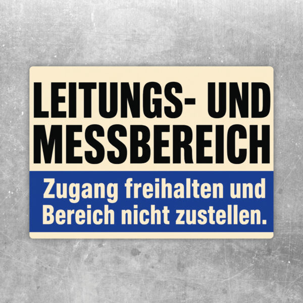 Aufkleber Leitungs- und Messbereich mit farbigen Leitungen und Hinweis Zugang freihalten, querformatig auf grauem Untergrund.