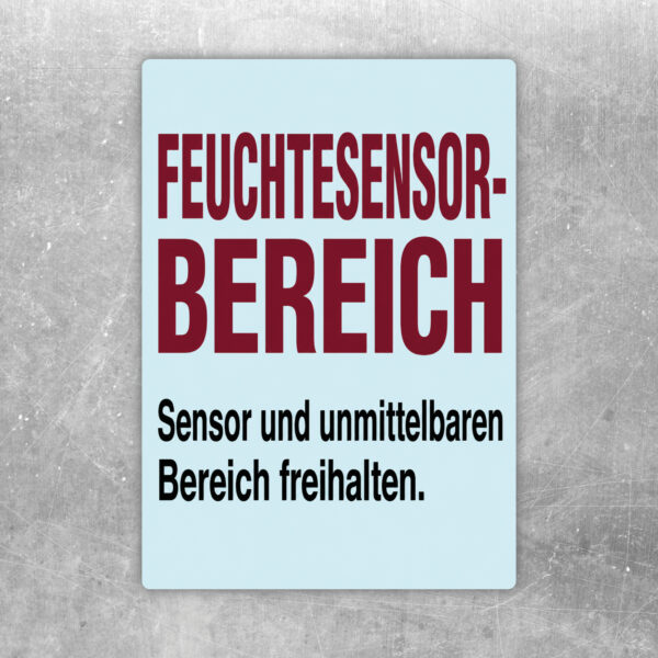 Aufkleber Feuchtesensor-Bereich mit Sensor-Grafik und Hinweis, den unmittelbaren Bereich freizuhalten.