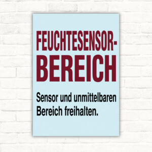Feuchtesensor Schild mit Wortlaut „Sensor und unmittelbaren Bereich freihalten“ und grafischem Sensorbereich.