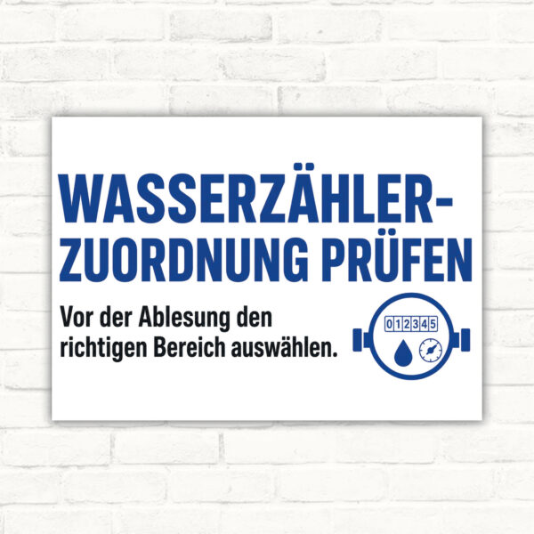 Querformatiges Schild mit Text „Zählerzuordnung prüfen“ und „Vor der Ablesung den richtigen Bereich auswählen“.