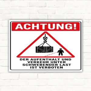Warnschild mit rotem Dreieck und Kranlast, Text: Aufenthalt und Verkehr unter schwebender Last ist verboten.